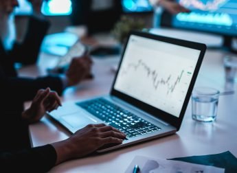 Traders team making stock market analysis inside hedge fund office - Focus on hand